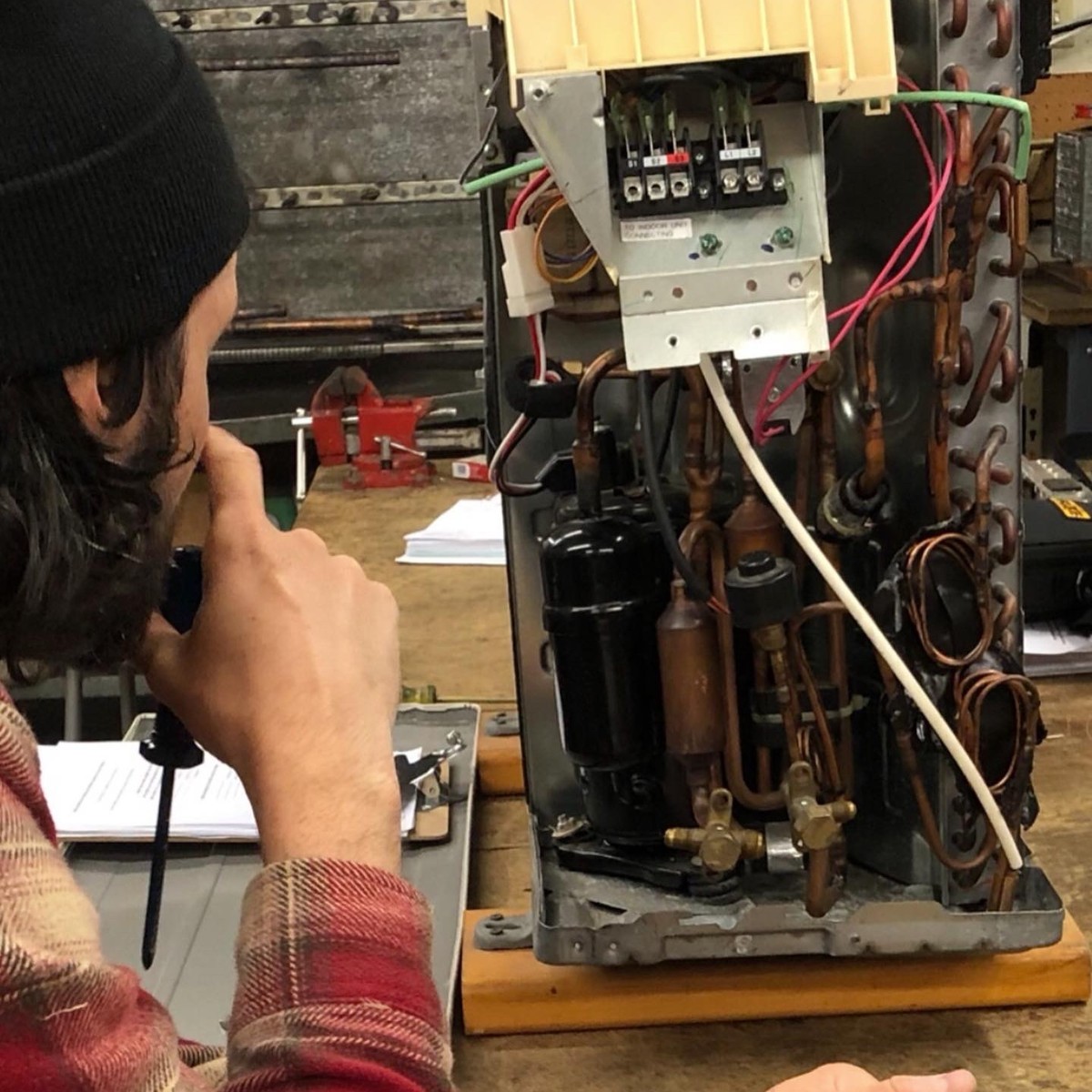 Student running a diagnostic check on HVAC training equipment