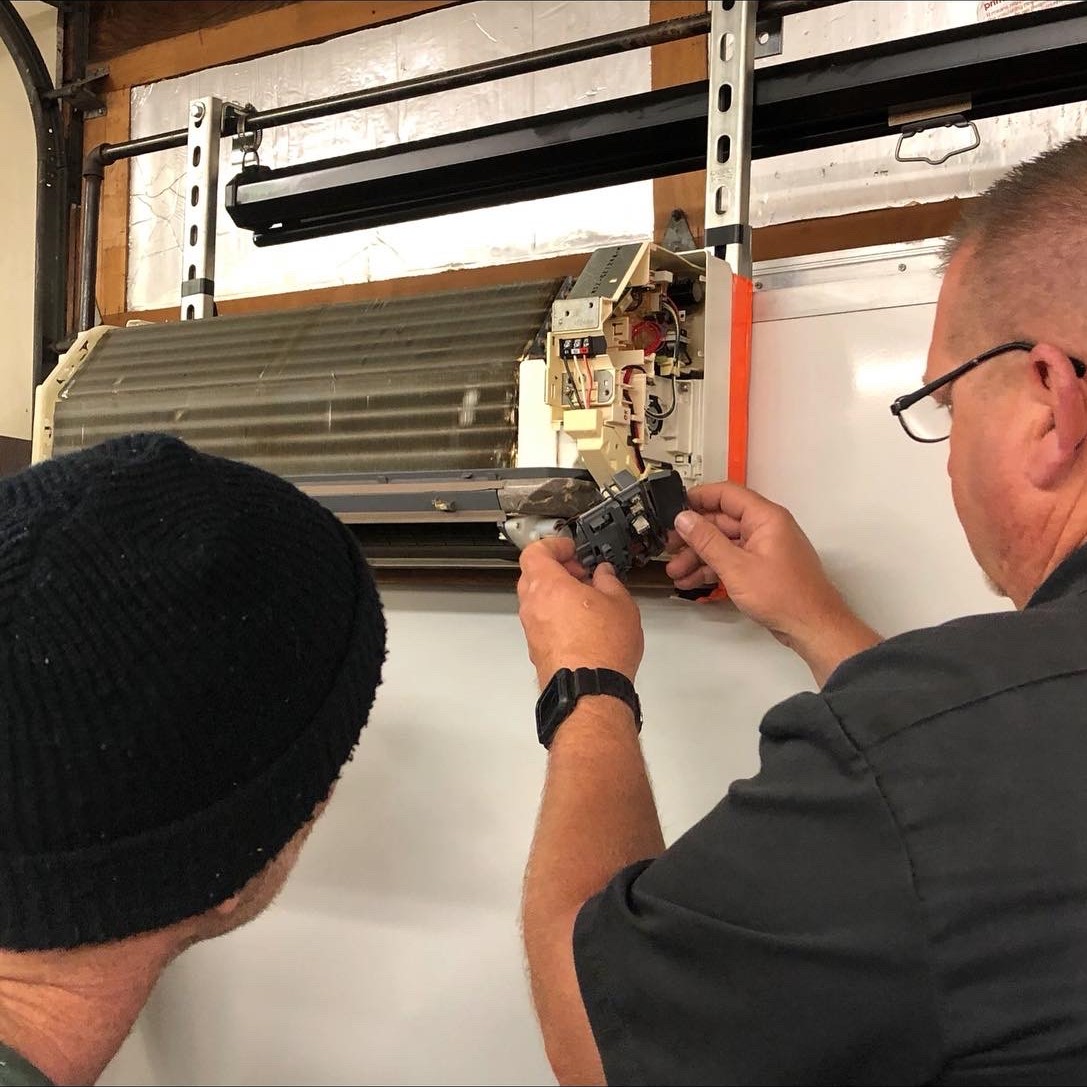 Instructor walking a student through HVAC equipment in the lab